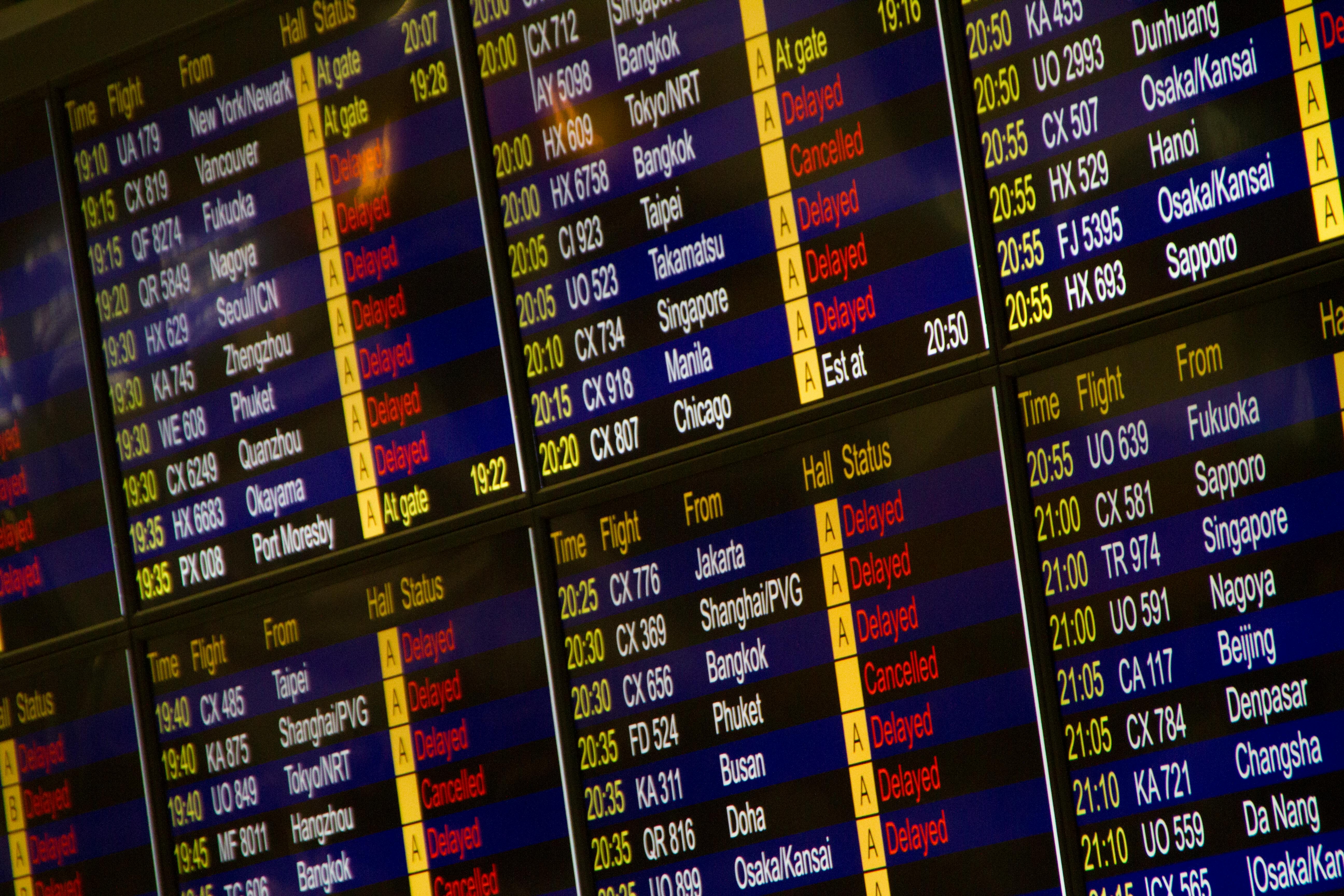 An airport departure board showing delayed flights